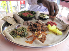 Injera, the staple of Ethiopian cuisine, is a sour fermented flatbread with a slightly spongy texture, traditionally made of teff flour.