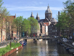 This is the Oudezijds Voorburgwal also often referred to as the Oz Voorburgwal canal. The Basilica of Saint Nicholas can be seen in the background.