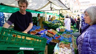 A greengrocer at the morning market in Amsterdam