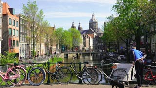 This is the Oudezijds Voorburgwal also often referred to as the Oz Voorburgwal canal. The Basilica of Saint Nicholas can be seen in the background.